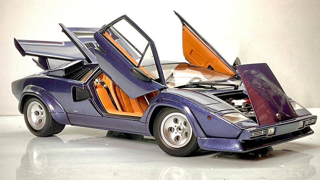 Lamborghini Countach Kyosho blu scuro con portiere e cofano anteriore aperti, interni color cuoio